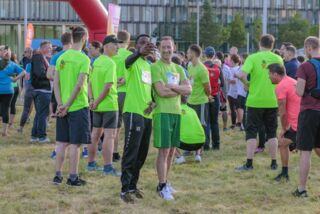 Teilnehmende des Förderturm-Firmenlaufs in grünen Laufshirts – Gruppenfoto vor dem Start